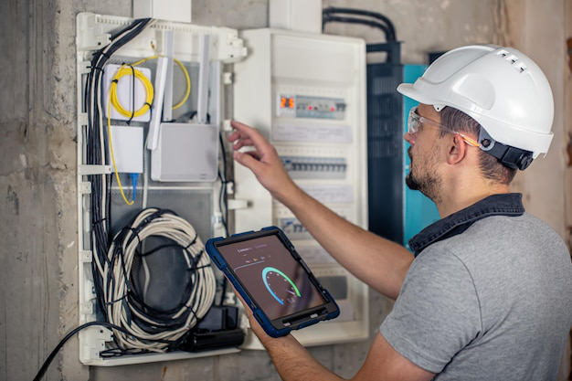 An electrician examining a home’s electrical panel