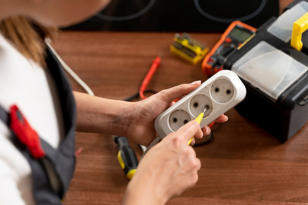 An electrician repairing an overloaded circuit